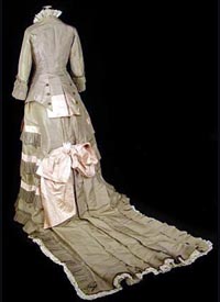  1875 sage green silk gown (back view) - Courtesy of antiquedress.com