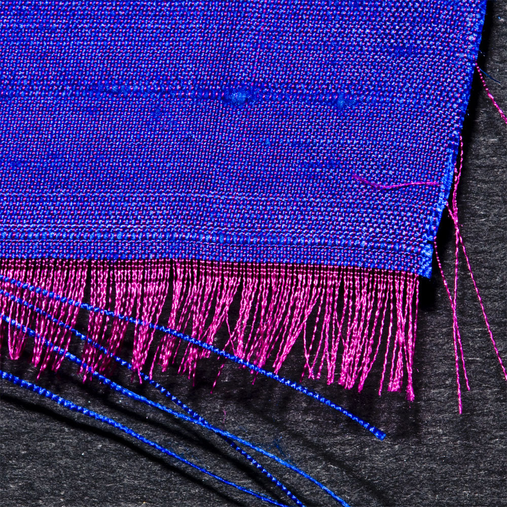Iridescent doupioni silk, showing the two colors of yarns