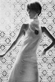 the classic cut out look by Biba   white drill dress with keyhole cut out over the chest area and cutaway armholes